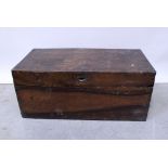A large wooden travel trunk with black painted handles and brass corners, length 90cm.