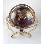 A large hardstone globe with mother of pearl and other stones inlaid,