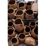 A large quantity of Melling Pottery tavern jugs in the antique style of coopered barrel design,