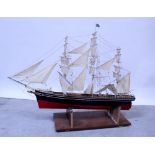 A scratch-built wooden model barque three mast sailboat with black body and red hull, length 90cm.