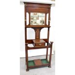 An Edwardian inlaid mahogany hallstand with bevelled mirror plate above inlaid floral design and