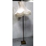 A gilt metal standard lamp in the form of a Corinthian column on a stepped square base,