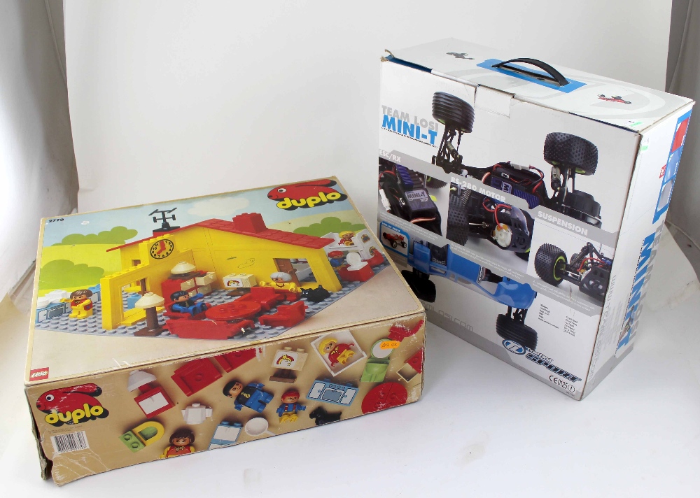 A boxed Lego Duplo building set and a Team Losi Mini T remote control car (2).