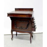 An Edwardian mahogany Davenport with small drawer over lift-up top with fitted interior,