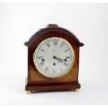 A Comitti of London oak mantel clock, the white dial set with Roman numerals,