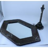 An Arts & Crafts beaten copper wall mirror of lozenge shape with fleur-de-lys to the top and bottom