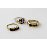 A 9ct gold dress ring set with five purple stones, size I,