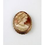 A yellow metal brooch set with a shell cameo of an elegant lady, with gold safety chain, length 5.