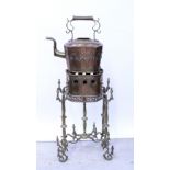 An early 20th century North African ornate copper and brass stand with large kettle.