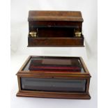 A burr walnut letter box with pen tray and ink wells to either side,