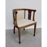 An Edwardian inlaid mahogany tub chair with pierced fretwork, upholstered in cream floral fabric,