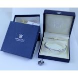 A boxed hallmarked silver bangle, marked 925, set with three chip diamonds,