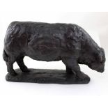 A large bronzed metal figure of a bull, height 23cm, length 38cm (af).