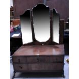 A mid-20th century triple mirror back dressing table, three frieze drawers over one lower drawer,