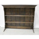 A 19th century oak dresser top comprising two shelves with plate grooves, on stile uprights,