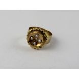 An Edwardian 9ct gold dress ring set with four seed pearls and diamond chip, Size K, approx 3g.