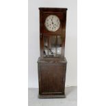 A 1920s oak-cased drop-dial wall clock,