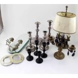 A mixed lot of candlesticks to include two pairs of candlesticks, a chamber stick,