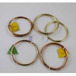 Three 9ct gold bangles, approx 41g, and two yellow metal bangles, unmarked (5).