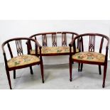 An Edwardian inlaid mahogany part parlour suite with pierced uprights on square tapering supports,