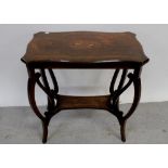 An Edwardian mahogany inlaid occasional table with shaped top and bowed legs united by an undertier,