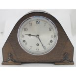 An early 20th century oak-cased mantel clock with silvered dial,