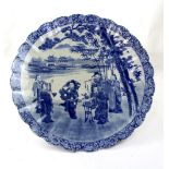 A Chinese blue and white printed and hand painted charger depicting musicians and a dancer in a