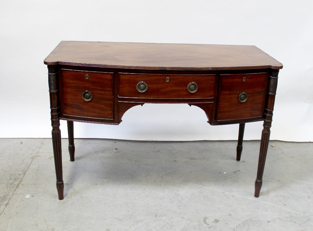 A 19th century mahogany bow-front sideboard, the top shaped with corner lugs and fitted glass top,