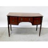 A 19th century mahogany bow-front sideboard, the top shaped with corner lugs and fitted glass top,