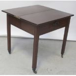 A George III mahogany foldover tea table with single drawer and brass drop handle,