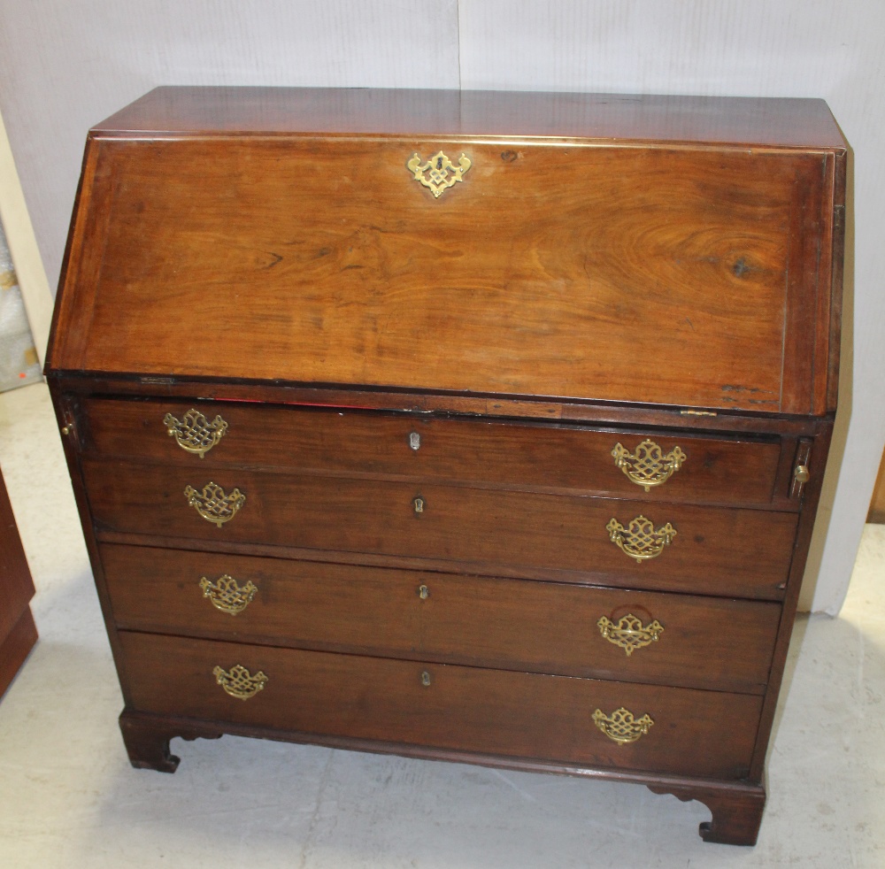 A George III mahogany bureau with fitted interior over four long drawers, on bracket feet,