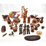 A group of carved tribal wooden figures including, three mid century African standing figures, Maori