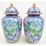 A pair of Chinese cloisonné enamel vases painted with butterflies and floral sprays, on cobalt