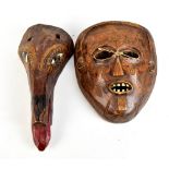 A carved Thai mask with painted detail and a carved African mask, length 31cm and 24cm (2).