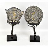 A pair of Indonesian Wayang pierced leather and buffalo horn shadow hand screens on stands, height