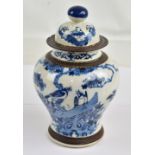 A late 19th century Chinese porcelain lidded baluster vase painted in underglaze blue with birds