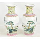 A pair of 20th century Chinese porcelain baluster vases decorated in enamels with floral scrolls and