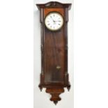 An early 20th century walnut cased Vienna style wall clock, the circular enamelled dial set with