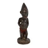 A Baule carved wooden scarified African figure with loin cloth, height 27.5cm.