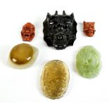 Two Japanese Meiji period ojime beads carved as noh masks, each signed, each 3cm, three carvings and