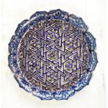 A 19th century Turkish Iznik-style earthenware cobalt glazed reticulated floral motif platter,