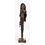 An Indonesian ancestor staff with figure emanating from the mouth of a snake, now presented on
