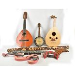 A mixed lot of assorted musical instruments including a modern lute, Spanish folk guitar,