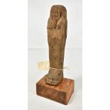 A carved Egyptian wooden Ushabti, height 26.5cm.Additional InformationBears paper label inscribed '