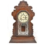 ANSONIA CLOCK COMPANY OF NEW YORK; a stained oak cased gingerbread mantel clock, the circular dial