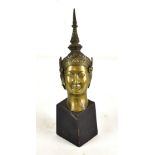 A late 19th century Southeast Asian bronze bust with pronounced spike to the headdress, now