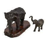 A Japanese Meiji period bronze figure of an elephant raised on an associated wooden stand, unsigned,