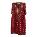 A Central Asian Suzani silk woven ceremonial dress with detailed flowers on a red ground with 'coin'