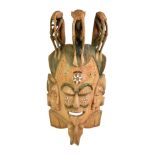 A massive early 20th century hardwood carved African mask based on a Fante Ghanaian example, the