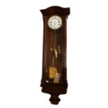 An early 20th century beech and rosewood cased Vienna style wall clock, the ornate circular dial